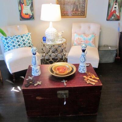 Lovely accent chairs, beautiful red trunk, decor pillows throughout & art