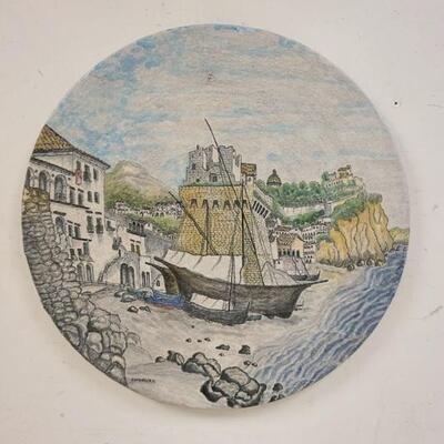 1109	LARGE POTTERY WALL PLAQUE SIGNED RAIMONDO. R. 91. TEXTURED PAINTING OF SHIPS & VILLAGE, 27 1/2 IN DIAMETER
