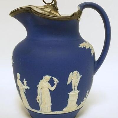 1017	WEDGWOOD ONLY DARK BLUE JASPERWARE PITCHER, HAS WEIGHTED METAL LID, HAS RECEIPT OF PURCHASE IN 1991 FROM A KENTUCKY DEALER, 9 1/4 IN...