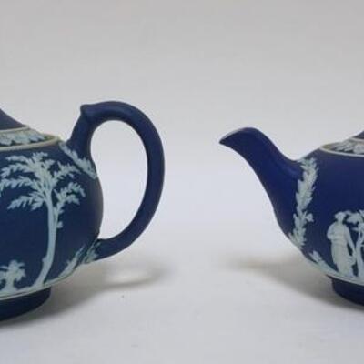 1119	2 WEDGWOOD JASPERWARE TEAPOTS MADE IN ENGLAND, BOTH HAVE FITTER RIM CHIPS, ONE HAS A CHIP ON THE LID, TALLEST IS 5 1/4 IN HIGH
