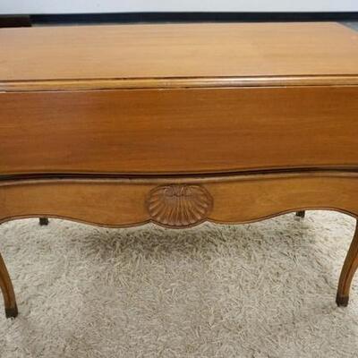 1203	SHELL CARVED DROP LEAF TABLE HAS A DRAWER IN THE LOWER SECTION, 21 IN X 35 1/2 IN CLOSED, DROPS ARE 7 1/2 IN. 27 IN H 
