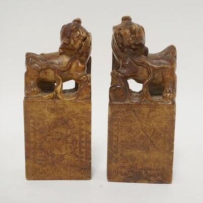 1065	PAIR OF ASIAN STONE CARVINGS, FOO DOGS, ONE HAS A SMALL REPAIR ON THE SIDE
