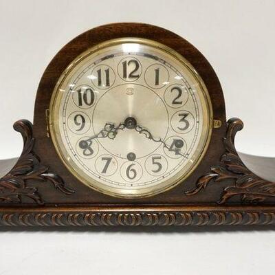1155	HOWARD MILLER MANTLE CLOCK IN A NICELY CARVED CASE W/WESTMINSTER CHIME, ORIGINAL BRASS LABEL ON THE BACK, 22 IN WIDE X 9 3/4 IN HIGH
