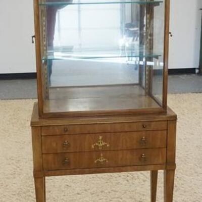 1195	WILLIAM A. BERKEY DISPLAY CABINET A DIVISION OF JOHN WIDDICOMB. HAS THREE DRAWERS , GLASS SHELVES, AND MIRROR BACK. 26 3/4 IN 62 IN H 
