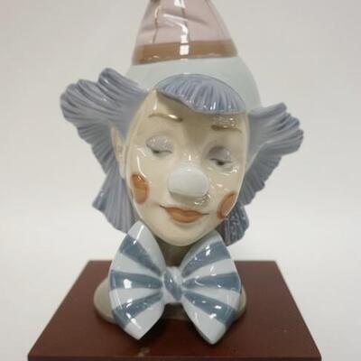 1143	LLADRO CLOWN HEAD, COMES W/ WOODEN BASE, 9 1/2 IN HIGH
