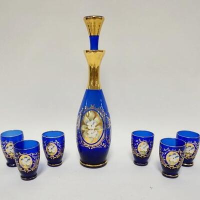 1128	COBALT BLUE W/GOLD GLASS 7 PIECE CORDIAL SET, APPLIED PORCELAIN FLOWERS, DECANTER IS 11 1/2 IN HIGH
