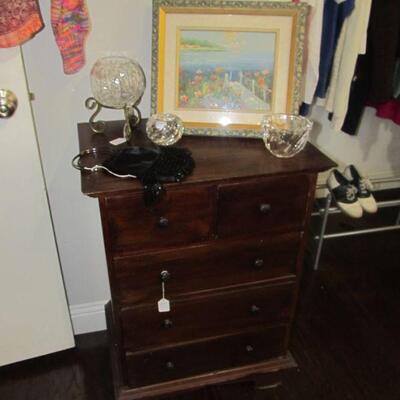 Framed painting w/ selection of crystal vases. Antique small chest of drawers