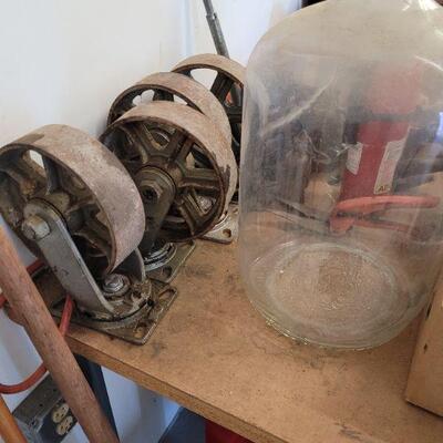 large steel caster wheels and a glass 5 gallon bottle with top