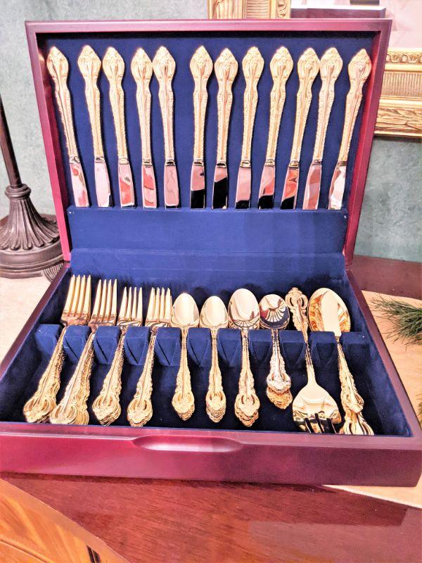 One of two sets of gold plated flatware