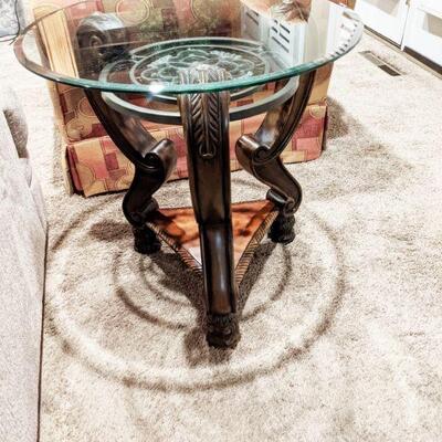 one of a pair of round glass top end tables