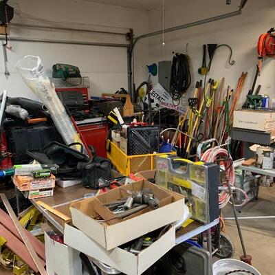The garage is packed with tools plus Two sheds full