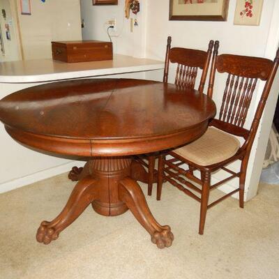 Round oak table with 4 chairs (3 matching, 1 coordinating) - $325