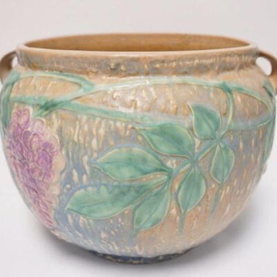 1018	ROSEVILLE WISTERIA BROWN POT. HAS SMALL NICK ON THE INNER TOP RIM,  & GLAZE FLAKE ON THE BASE, ALSO HAS A HAIRLINE & GLAZE FLAKE...