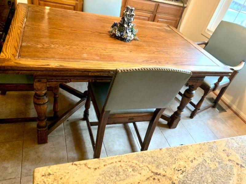 Feudal Oak style oak dining table with leather seat chairs and two built in extensions