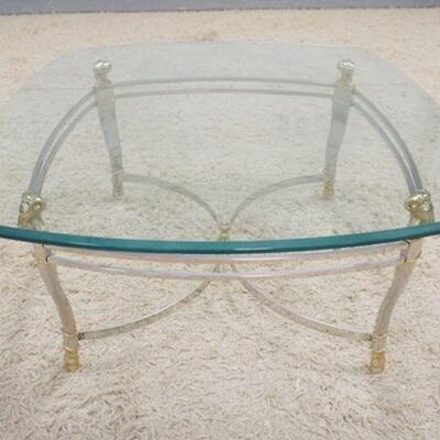 1126	BRASS, CHROME & GLASS COFFEE TABLE, HAS BRASS RAMS HEAD TOP SUPPORTS & HOOF FEET, GLASS IS BEVELED, 38 IN X 17 1/2 IN HIGH
