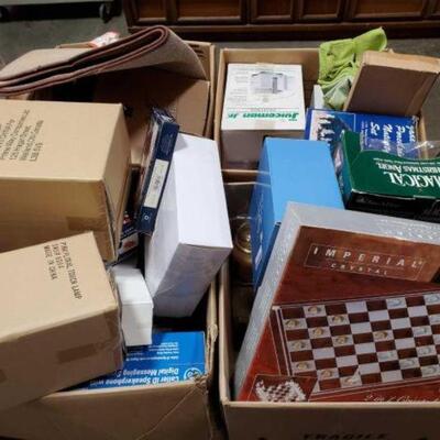 #4932 â€¢ 4 Boxes Of Misc Items Includes Juicer, Rug, Rags, Globe Lamp, Porcelain Nativity Set, Dishes, Food Tent, Doll, Donut Maker,...