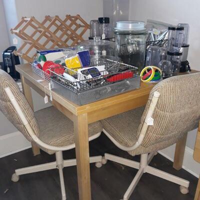 expandable kitchen table, four chairs with caster wheels, kitchen storage containers, small appliances, and more.