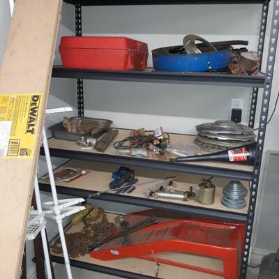 Metal shelving, car parts, and tools
