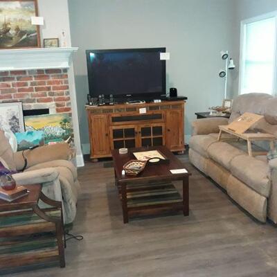 Plasma TV, entertainment console, coffee table with matching side tables, electric recliner, and an electric reclining sofa.