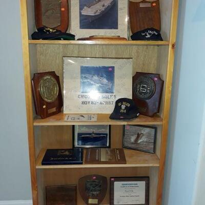 US Navy award plaques and photographs from the aircraft carriers on which Chief Petty Officer Soles served.