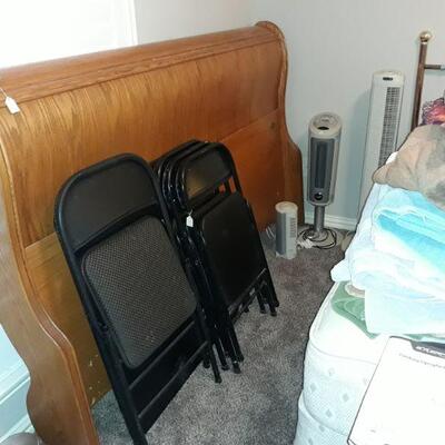 king headboard and a folding card table with 4 chairs