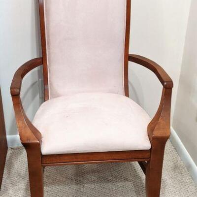 One of a pair of arm chairs with dining table