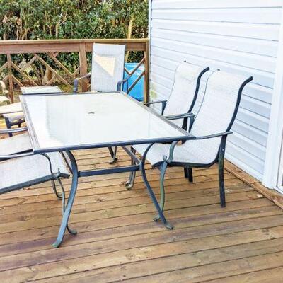 Rectangular outdoor patio table and chairs.  Chairs adust.  One footstool