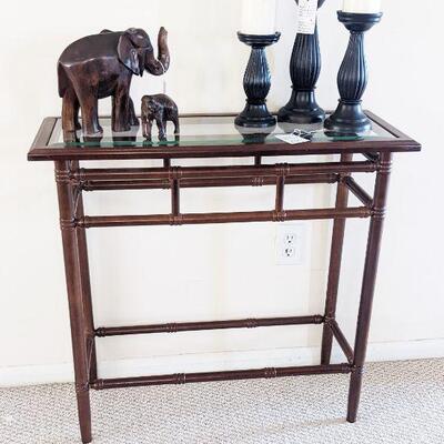 Bamboo look metal accent table with glass top