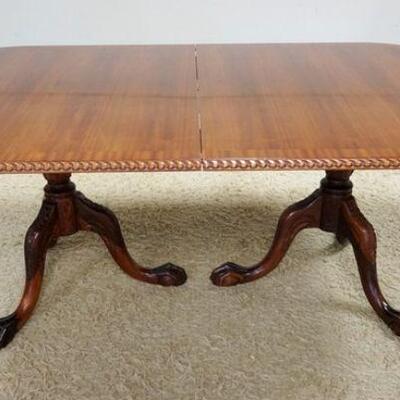 1019	BANDED MAHOGANY DOUBLE PEDESTAL DINING TABLE W/ BALL & CLAW FEET. HAS TWO 18 3/4 IN LEAVES. 76 IN X 46 IN CLOSED 30 1/4 IN H 
