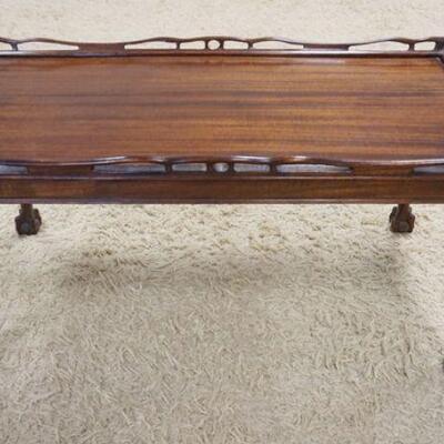 1011	MAHOGANY BALL & CLAW FOOT COFFEE TABLE HAS A FRETWORK GALLERY & CARVED KNEES. 35 1/2 IN X 18 1/2 IN, 17 1/2 IN H 
