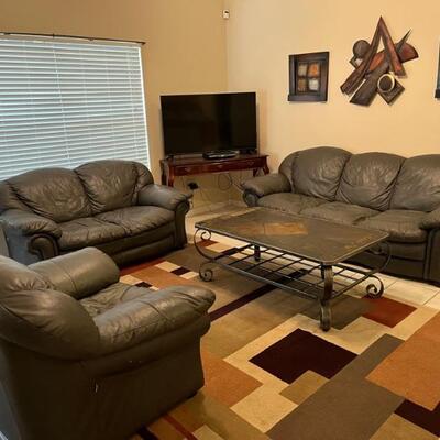 Leather Couch, Loveseat and Chair ($150), Coffee  Table 50”x30” ($50), Smart TV 42”x28” ($100) Wall Hangings ($45 set)