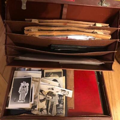 Bill Fee Collection: Briefcase filled with black and white photos, newspaper ads, logs of fees paid and expenses.