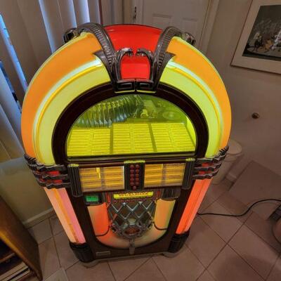 Vintage Wurlitzer 1015 Jukebox. Asking 3800 but Taking bids. Works and plays but the arm that transfers records to turntable is not...
