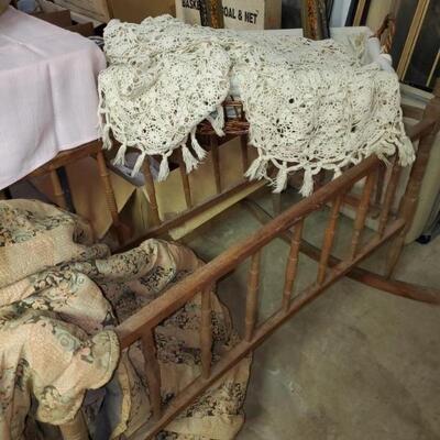 Rocking cradle, crocheted bedspread