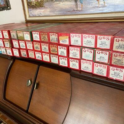90 rolls accompany this player piano