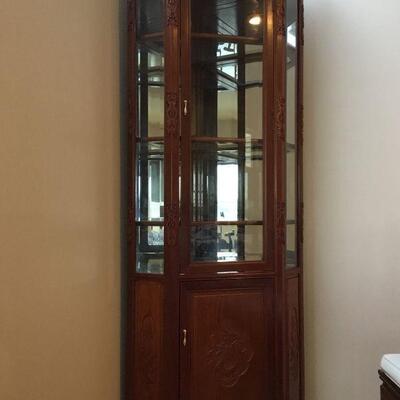 Rosewood Corner Display/Curio Cabinet with Beveled Glass Doors, Mirrored Back and Glass Shelves. Cabinet is 79in tall, 21.5in deep and...