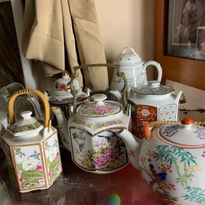 Teapots, some with cups