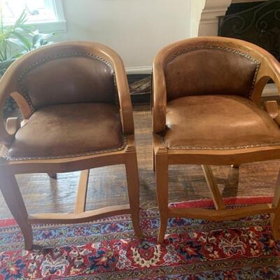 Pair Regency Meets Western Leather Club Chairs
Amply Cushioned, Upholstered in Quality Leather with Brad Trim in a Light Oak Wood Frame...