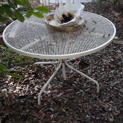 Wrought iron patio table and a large clam shell