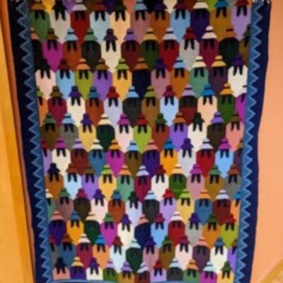 Woven Peruvian Cholitas Wall Hanging. This colorful piece measures 43” x 62”.
