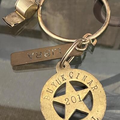 Büyük Hotel Vintage Key Chain & Libra key chain. Also come with a whistle. All items are in used condition with some wear.