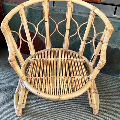 Vintage Curved Rattan Chair with a lovely design! The cushions have some stains.  The chair measures about 29.5