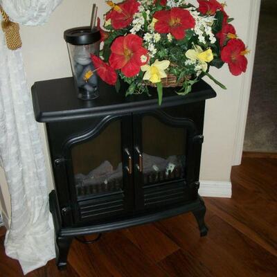 Black Electric Stove Fireplace ; Silk Flower Arrangement.