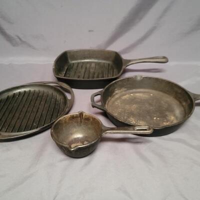 (4) Cast Iron Cookware: 2-Lodge, 1-Le Creuset, 
1-Emeril