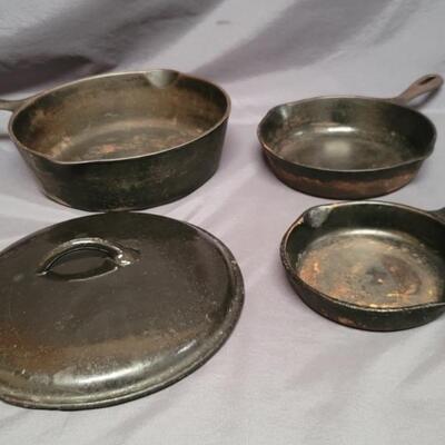 (4) Cast Iron: 
2- Wagner Dutch Oven & Lid, 
1-Wagner Small Skillet
1- Unmarked 8in Skillet