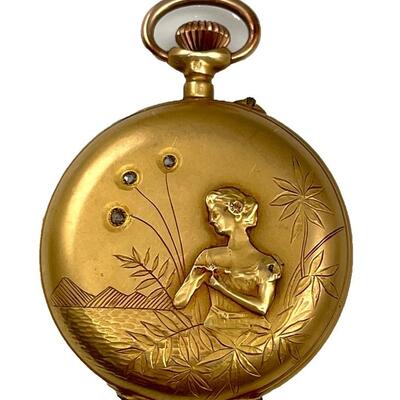 An Art Nouveau Swiss pocket watch with front cover depicting an Art Nouveau maiden among engraved foliage and landscape by the sea. Three...