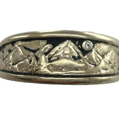 A 14kt white gold ring with mountain and trees, diamond in the â€œskyâ€. Signed. Size 10 1/2, 5.5 dwt.