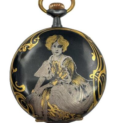 An Art Nouveau hunter case pocket watch with iodized black or niello finish, gold tone accents, and lovely portrait of a seated lady at...