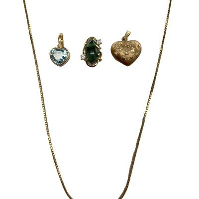 A grouping of four items including a 14kt gold and sky blue topaz heart pendant, a 14kt green tourmaline and diamond slide pendant, and a...