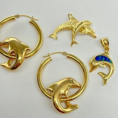 "Included: A pair of 14kt yellow gold dolphin and hoop earrings, 1 1/2â€ 2.5 dwt.
14kt bright cut dolphin pendant, 1.88 dwt. 
14kt...